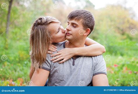 Girl Kiss A Guy On The Cheek Stock Image Image Of Holding Outdoors 27398789