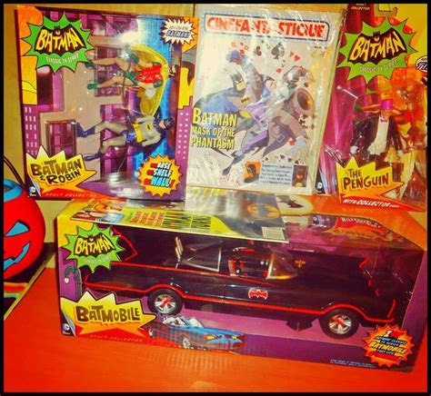 The Batman Car Is In Its Box And Its Next To Some Other Toys