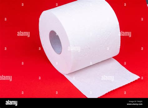 Toilet Paper Roll On Red Background Half Unrolled Stock Photo Alamy