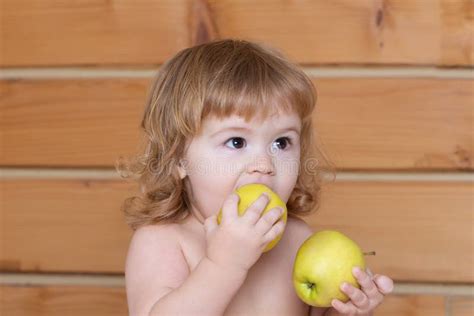 Hungry Little Baby Boy Eating Apple Kid With Fresh Fruit Stock Image