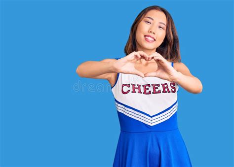 Young Beautiful Chinese Girl Wearing Cheerleader Uniform Smiling In