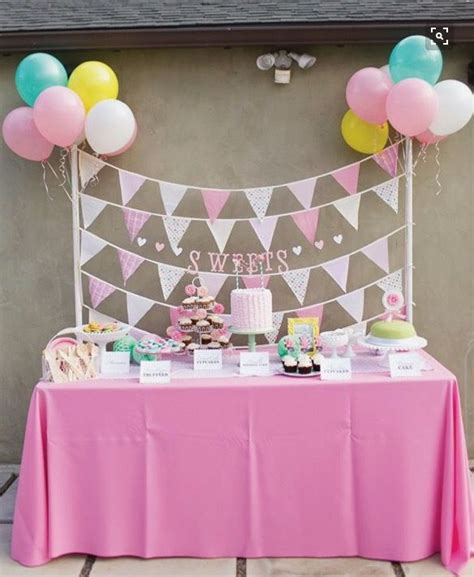 A Pink Table Topped With Lots Of Balloons