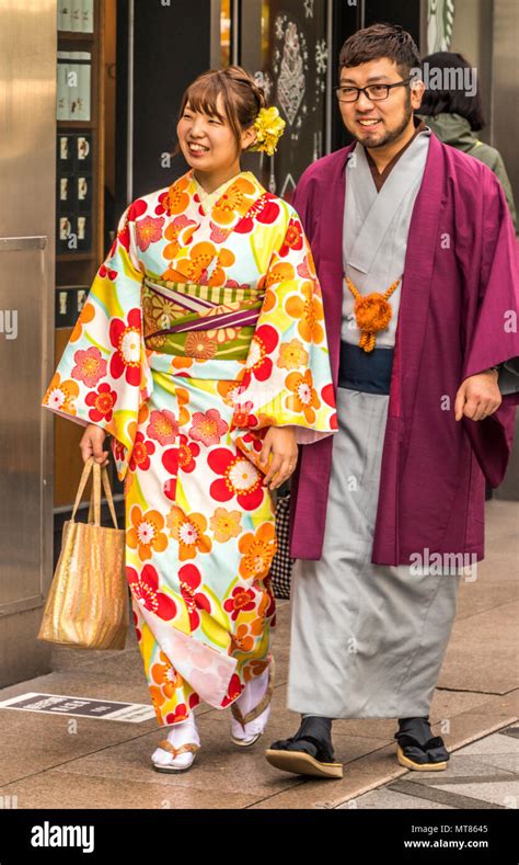 Men And Women Walking Round Kyoto Japan In Traditional Japanese Kimono