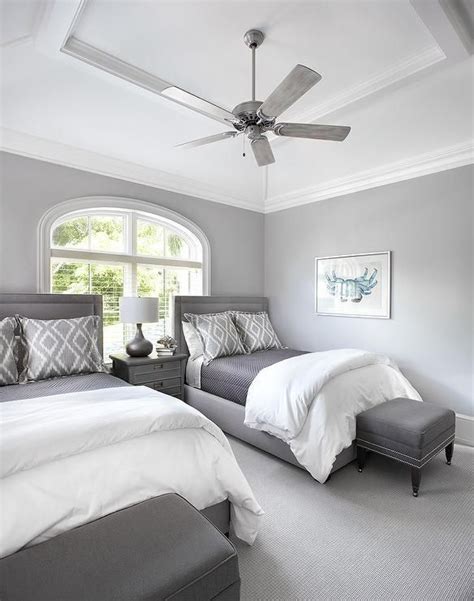 A Ceiling Fan Mounted To A Vaulted Tray Ceiling Hangs Over Matching