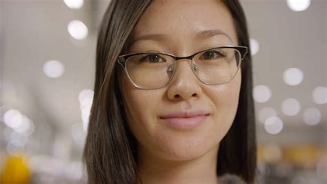 Portrait Shot Of Young Chinese Girl In Glasses Standing In Shop