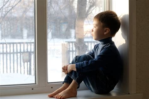 Boy Sitting On The Window Looking Out Stock Image Image Of Frost