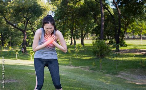 Young Female Have Chest Pain While Running In The Park Young Woman