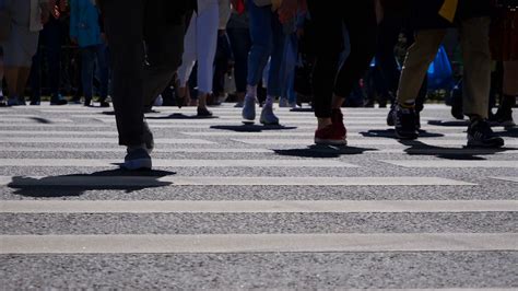 Low Angle Shot Of The People Walking On Pedestrian Crossing Of The Road