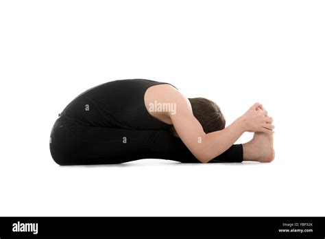 Athletic Young Man Does Yoga Exercises Seated Forward Bend Pose Stock