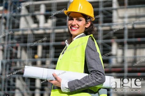 Female Civil Engineer With Construction Plans At Building Site Of High