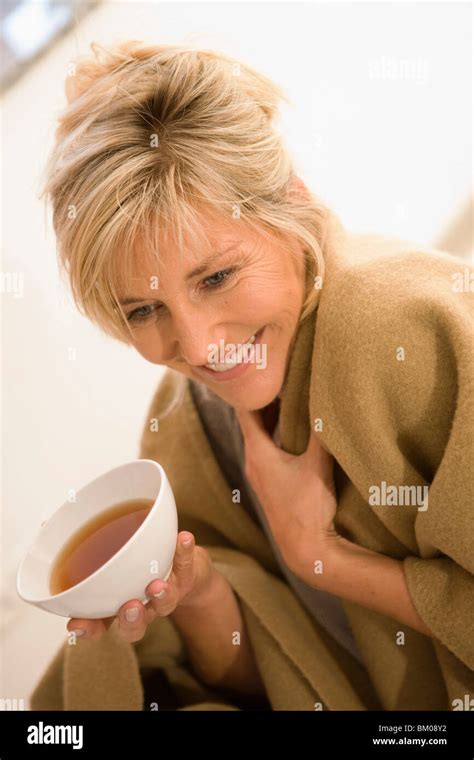 Happy Mature Woman Sipping Tea Hi Res Stock Photography And Images Alamy