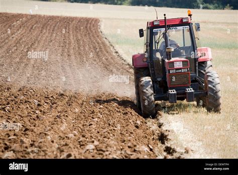 Agricultural machinery. Tractor ploughing the land. Mouldboard plough