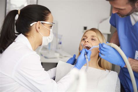 Two Dentists Doing Their Work In Dentists Clinic Dental Surgery By