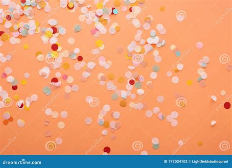 Decorative And Colorful Confetti On Orange Background Stock Image