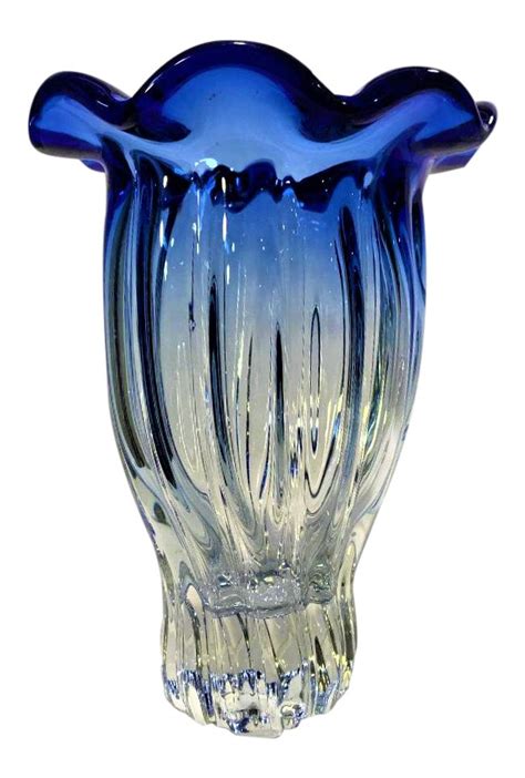 A Blue Glass Vase Sitting On Top Of A White Table