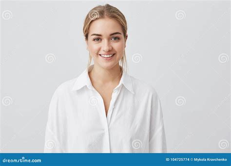 Cheerful Good Looking Young Woman Wearing White Shirt With Blonde Hair