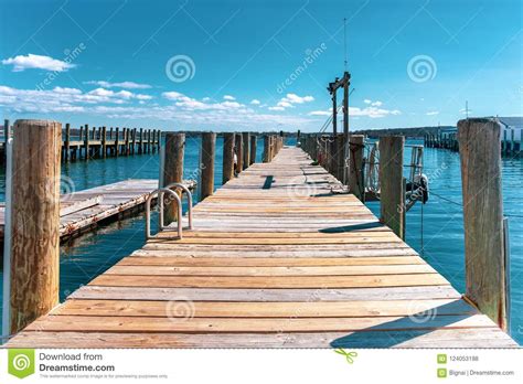 Wooden Dock Or Pier By The Lake In Turquoise Sky And White Cloud Stock