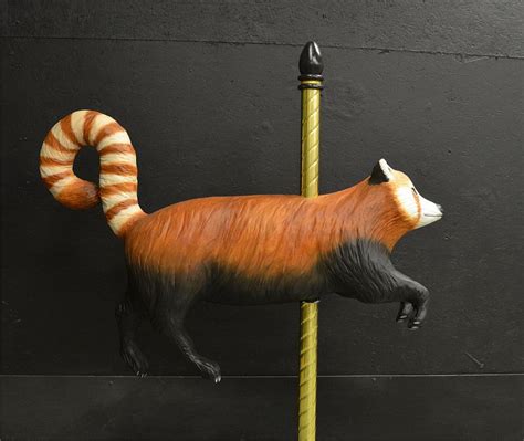 A Statue Of A Red And White Striped Fox On A Pole With A Black Background