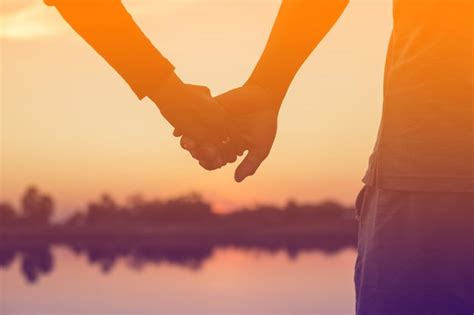 Premium Photo Silhouette Couple Holdings Hands Against Lake During Sunset