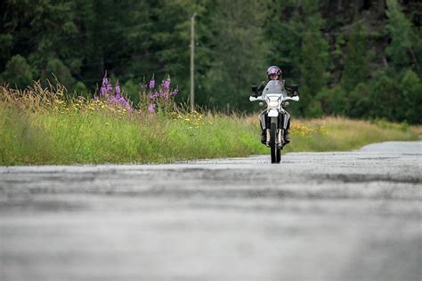A Woman Rides Her Motorcycle On A Cloudy Summer Day Photograph By