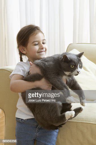 Young Girl Carrying Cat High Res Stock Photo Getty Images