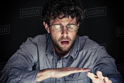 Man Looking Down With Shocked Expression On Face Stock Photo Dissolve