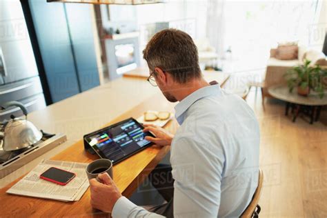 Businessman Using Digital Tablet Working From Home Stock Photo