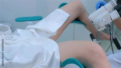 Patient And Doctor In Gynecological Office On Colposcopy Procedure Side View Legs Closeup