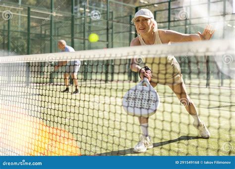 Old Woman Playing Padel Tennis In Open Air Tennis Court Stock Photo