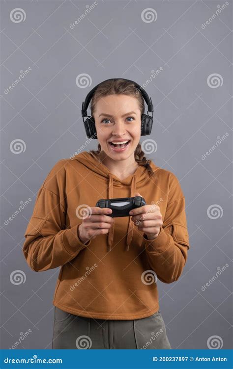 Portrait Of Happy Gamer Woman With Pigtails Playing Video Game Using