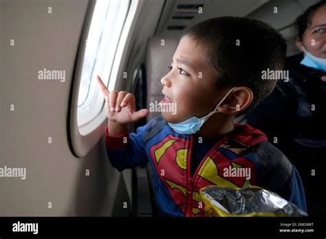 Yancarlos Amaya, 5, a migrant from Honduras, looks out an airplane