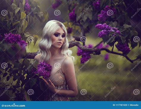 Portrait Of A Beautiful Sensual Young Blond Woman In Spring Blossoming Spring Garden Stock