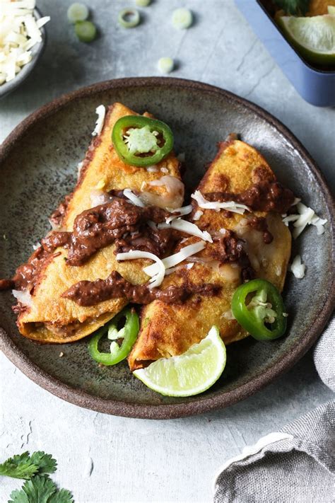 To serve, soften the tortillas in a microwave for 30 secs then pile the chicken on top, spoon over the sauce and roll up. Chicken Black bean Mole Enchiladas | Recipe | Mexican food ...
