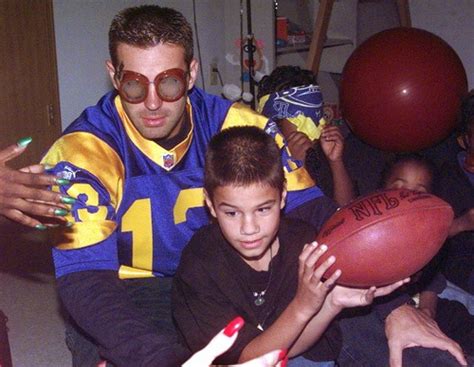 Quarterback Kurt Warner Holds His Adopted 10 Year Old Son Zachary Blind Since Birth While Pass