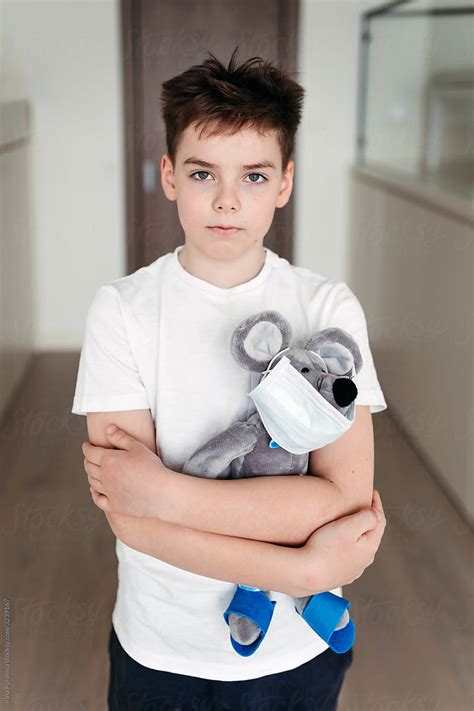 Portrait Of A Young Sad Boy With A Toy At Home By Stocksy