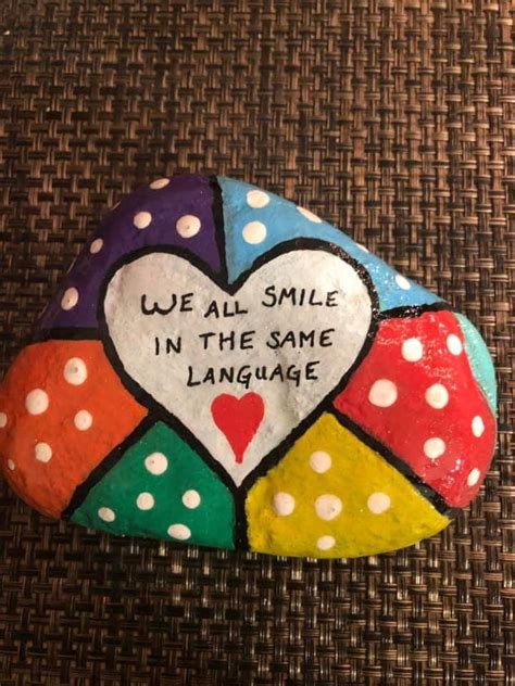 A Painted Rock That Says We All Smile In The Same Language