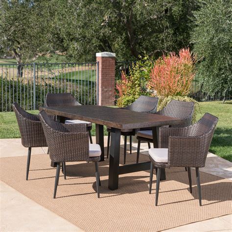Complete with a table, bench, and 4 wicker dining chairs, this set offers comfortable seating for 6 in the great outdoors. Porter Outdoor 7 Piece Wicker Dining Set with Light Weight ...