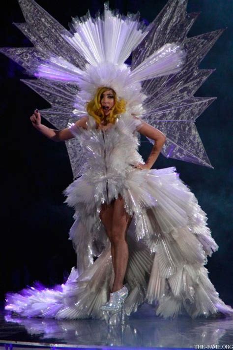 Lady In White Dress On Stage With Wings And Headpieces Made Out Of Plastic