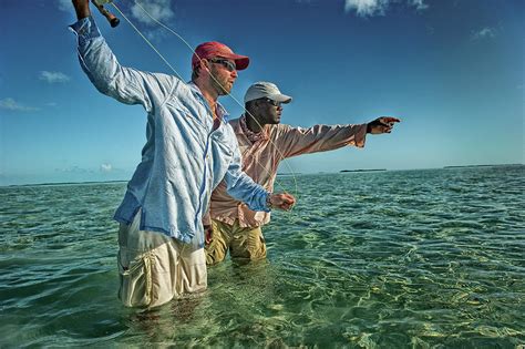 Fisherman With Bone Fishing Guide In Exuma Bahamas Photograph By