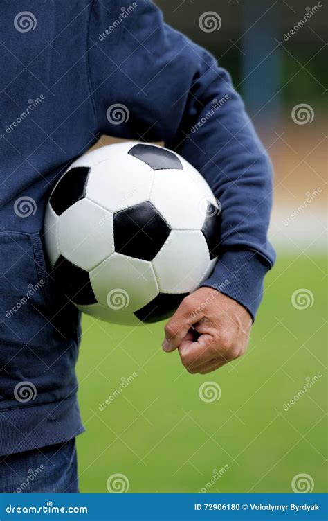 Hand Holding Soccer Ball On Stadium Stock Photo
