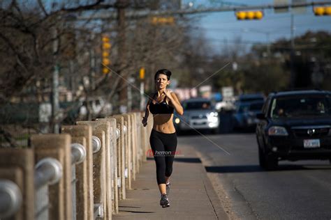 Serious Female Runner Training With Heavy Running Stride For Marathon