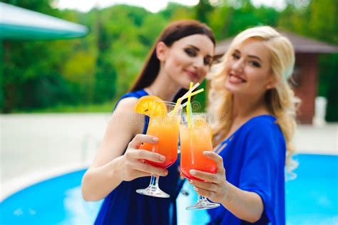 Beautiful Women In Bikini Drinking A Cocktails While Relaxing In The Swimming Pool Stock Image