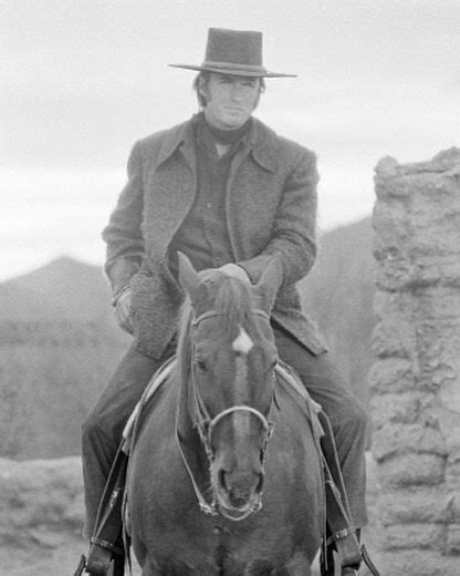 American Actor Clint Eastwood Riding A Horse On The Set Of The American