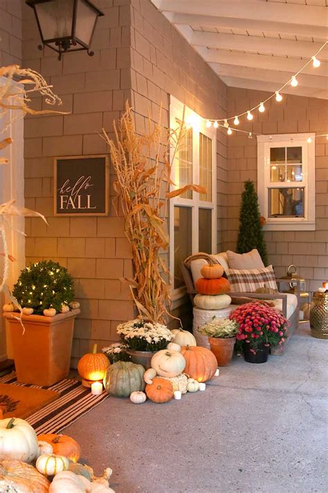 Hang a fall bouquet on the front door. Neutral Fall Porch Decor with Pumpkins and Cornstalks ...