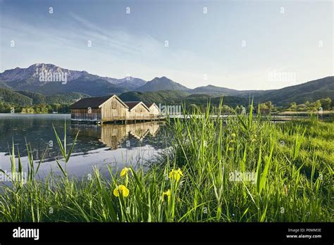 View Of Spring Landscape With Boathouses At Lake Kochelsee Bavaria