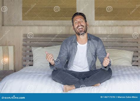 Interior Portrait Of S To S Happy And Handsome Man At Home In Casual Shirt And Jeans Sitting