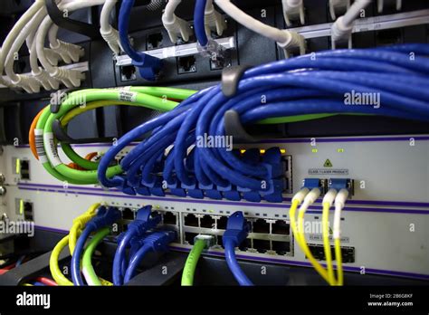 Ethernet Cables And Fibre Optic Cable Plugged Into Servers Stock Photo