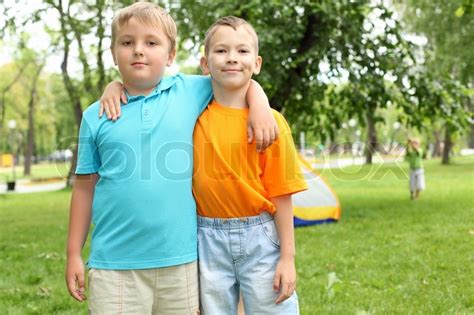 Have you ever noticed that you rarely see a gas station by itself? Two boys standing next to each other in the summer park ...