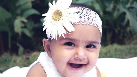 Smiley Cute Baby Girl Is Wearing White Daisy Flower Headband Lying On