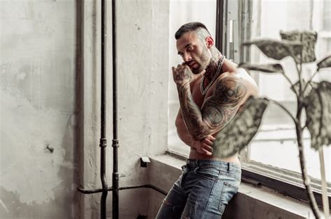 Premium Photo Fashion Portrait Of Sexy Naked Male Model With Tattoo And A Black Beard Standing